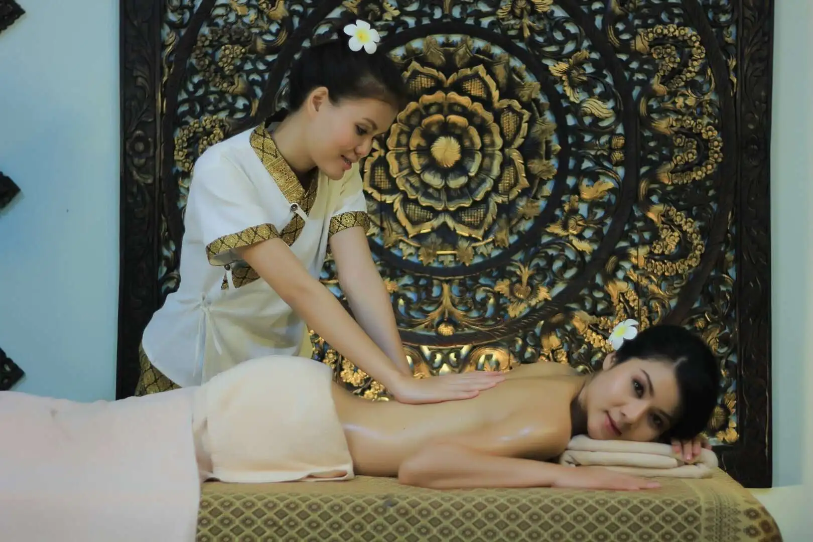Therapist performing an oil massage with gentle strokes